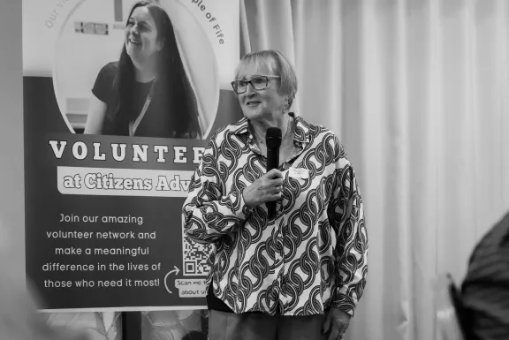A female director making a speech using a microphone at a conference