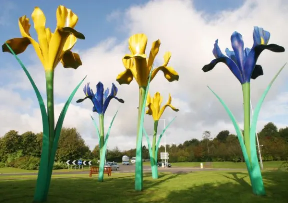 Large metal sculptures of yellow and blue flowers 