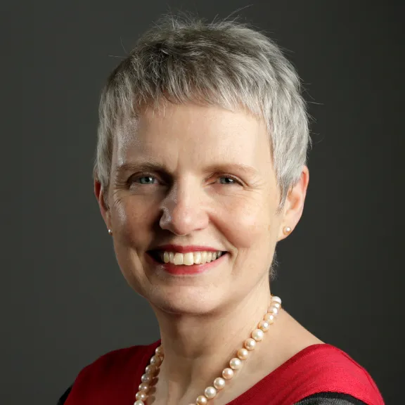 A portrait headshot image of a female 