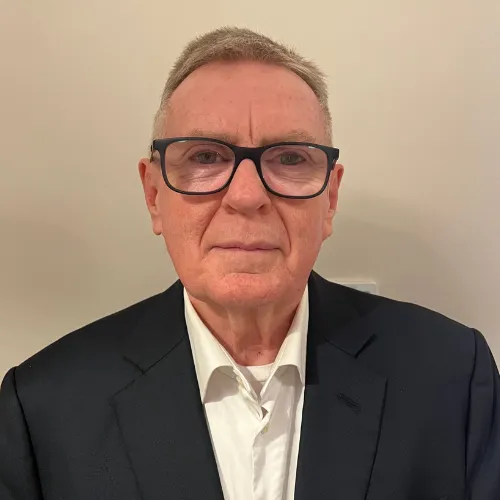 A portrait image of a male director 